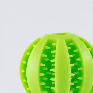 Green silicone dog chew toy ball with spike design for pet dental cleaning and interactive play.