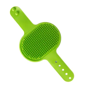 Green silicone pet massage brush for dogs and cats bath and grooming with adjustable strap.