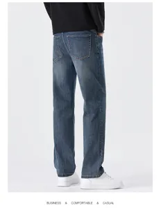 Detail view of men casual straight fit blue denim jeans showcasing back pocket and comfortable fabric.