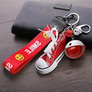 Mini red canvas shoe keychain with red webbing and jingle bells, cute bag pendant.