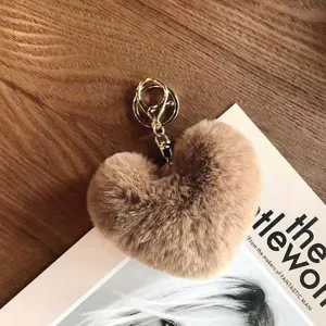 Chic heart-shaped fluffy faux fur pompom keychain pendant for stylish bags and keys decoration.
