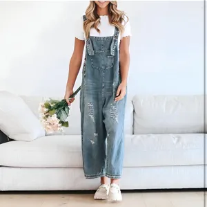 Distressed denim overalls detail view featuring ripped knees and relaxed fit casual style.