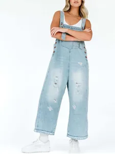 Vintage distressed light blue denim overalls for women, casual loose cropped jumpsuit style.