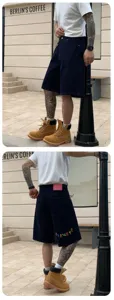 Men's loose fit blue denim shorts with colorful embroidery and stylish street design