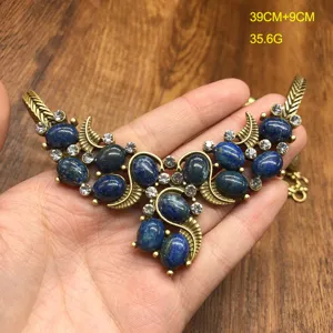 Vintage retro blue stone rhinestone alloy necklace detail view, elegant bronze jewelry.