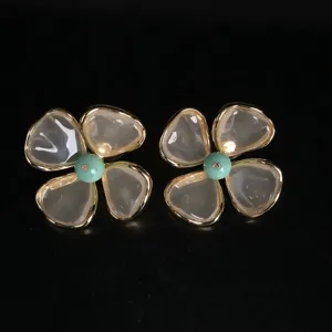 Elegant flower stud earrings with gold rims and blue center bead for women fashion.