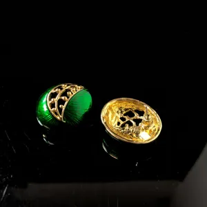 Vintage groene geemailleerde oorbellen gouden filigraan details achterkant pin close-up