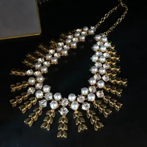Vintage gold-toned statement necklace with layered pearls, sparkling crystals and wheat fringe.