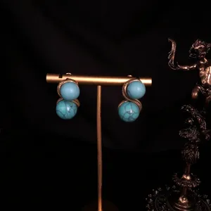 Vintage gold-plated turquoise double ball earrings detailed shot, elegant retro jewelry style.