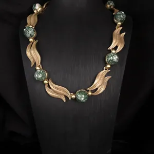 Vintage gold-toned leaf necklace with green stone bead inlay, antique style jewelry detail