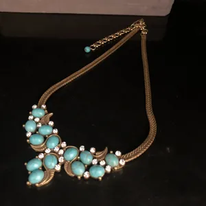 Detail view of vintage bronze turquoise rhinestone statement necklace ethnic jewelry.