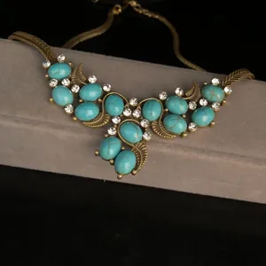 Close-up detail view of a vintage bronze turquoise rhinestone statement accessory.