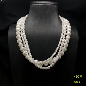Elegant multi-strand faux pearl necklace set, classic layered white bead design.