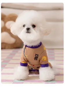 Detailed view of cute pet pajamas for small dogs, brown jumpsuit with space print and purple cuffs.