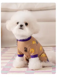 Cute pet dog wearing warm four-leg space themed apparel in cozy indoor detail scene.