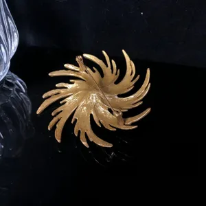 Vintage gold starburst brooch back view detail, textured metal pin design for women fashion.