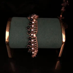 Vintage gold hollow bracelet featuring black glass cabochons and clear crystal details.