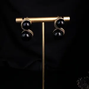 Vintage style black gemstone earrings with retro gold hollow metal frame for women chic jewelry display