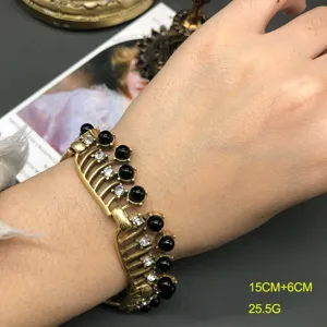 Vintage antique gold openwork bracelet with black glass beads and dazzling rhinestones for women.