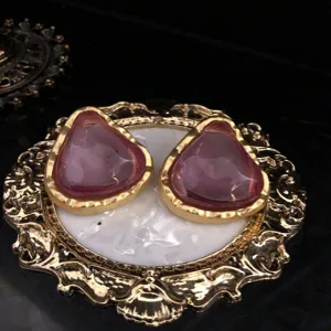 Vintage style jelly pink purple earrings detail close-up view showing elegant gold design.