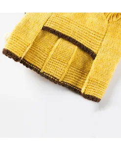 Close-up detail of cozy yellow knit pet sweater with brown trim, soft and warm winter wear.