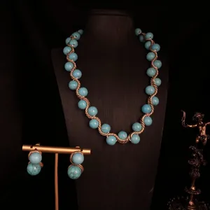 Vintage turquoise beaded necklace and earrings detail shot showing handmade gold wire design.