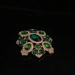 Vintage emerald green gemstone brooch detailed crystal rhinestone gold tone pin jewelry detail view