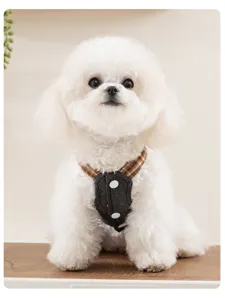 Close-up detail of stylish denim and plaid pet harness clothing for small dogs and cats.