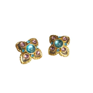Vintage retro style flower stud earrings with blue glass stones and elegant gold details.