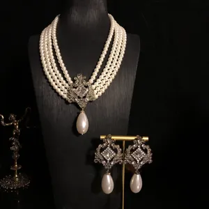Vintage multi-layer pearl necklace and earrings set with crystal pendant detail.