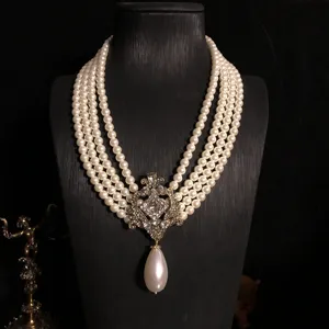 Retro court style multi-layer pearl necklace with vintage gold pendant and crystal details.