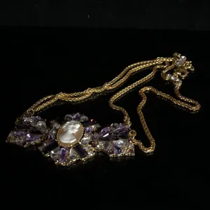 Vintage cameo pendant necklace with purple rhinestones and layered gold chains for women.