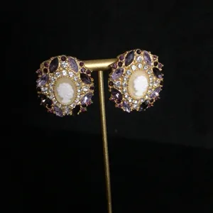 Vintage cameo rhinestone earrings detail, elegant purple crystal and gold design for women.