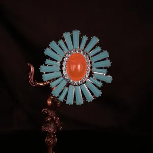Vintage blue and orange rhinestone flower brooch detail, elegant decorative pin for women.