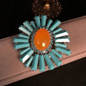 Vintage retro blue gemstone orange center flower brooch jewelry detail closeup elegant pin