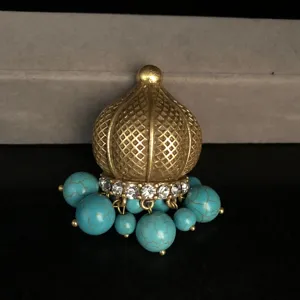 Vintage style gold textured dome turquoise bead rhinestone dangle jewelry accessory detail.