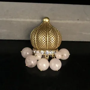 Vintage gold-tone filigree dome pendant with sparkling rhinestones and pink quartz bead drops