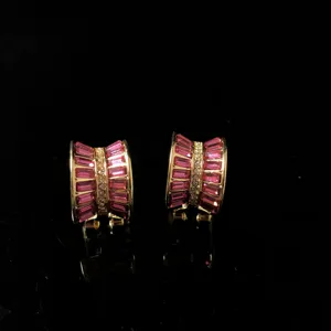 Vintage style gold-plated clip earrings featuring striking pink baguette crystals and sparkling clear rhinestones.