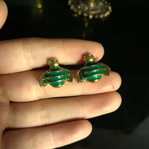 Detailed close-up of gold-plated green enamel bee stud earrings showcasing fine craftsmanship.