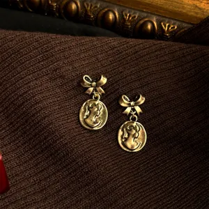 Vintage cameo bow earrings, retro bronze alloy drop earrings, elegant French style fashion jewelry.