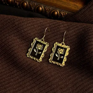 French vintage rose gold rectangle drop earrings detail, elegant antique style black jewelry.