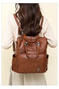 Detail view of the brown PU soft leather backpack, showing multi-pocket design and texture.