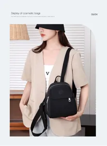 Casual black nylon mini backpack for women, lightweight travel daypack with front zip pocket.