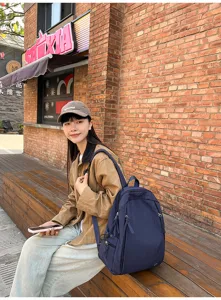 Casual navy blue backpack for women and students, lightweight waterproof travel school bag.