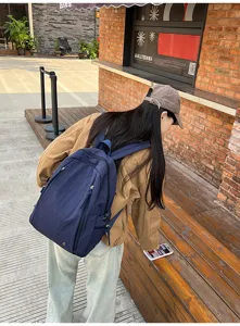 Outdoor lifestyle scene showing backpack detail, casual student travel shoulder bag style.