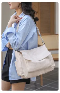 Casual crossbody bag detailed view featuring large capacity, wide strap and envelope flap design.