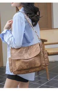 Detailed view of women casual messenger shoulder bag with vintage brown leather look and wide strap.