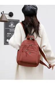Sac à dos décontracté imperméable pour femme, modèle pratique avec poches zippées.