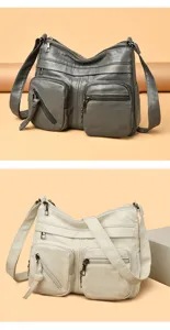 Close-up view of the multi-pocket soft leather shoulder bag showing zipper compartments and zippers.