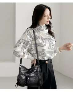 Detailed view of the women's black multi-pocket soft leather crossbody commuter shoulder bag.